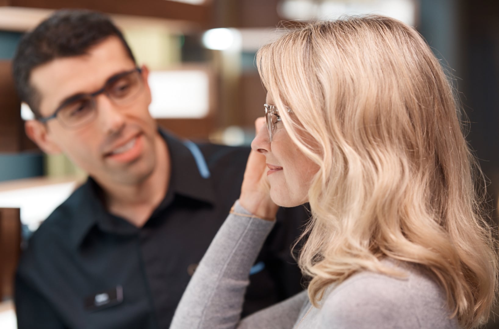 A client is trying on a pair of eyeglasses